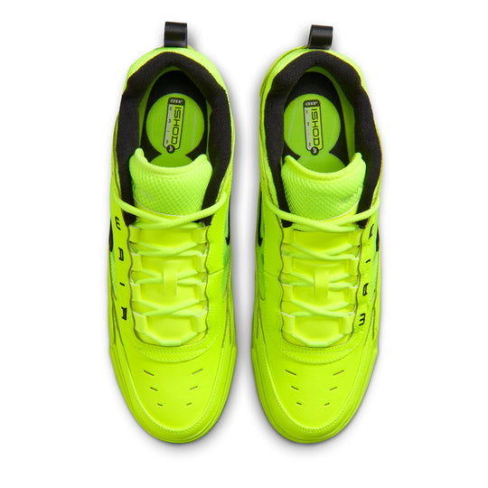 Pair of neon green sneakers with black accents on a white background