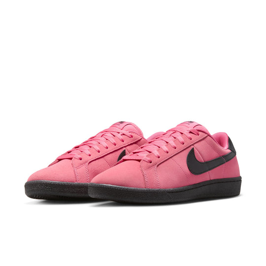 Pink sneakers with black Nike logo on a white background