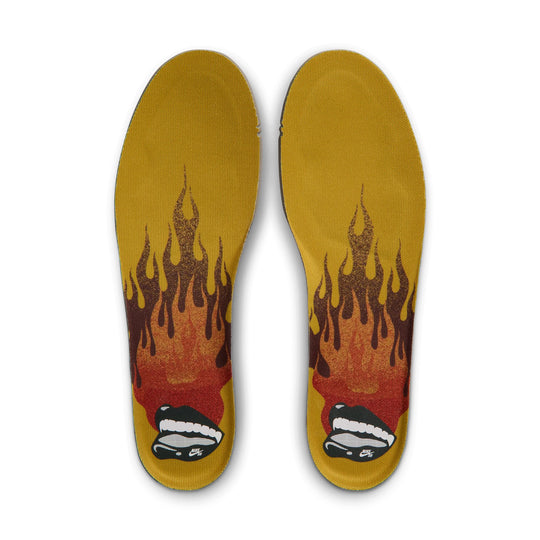 A pair of custom insoles featuring a bold flame graphic in red, orange, and yellow, with a small black and white sneaker illustration at the heel, shown against a plain white background.
