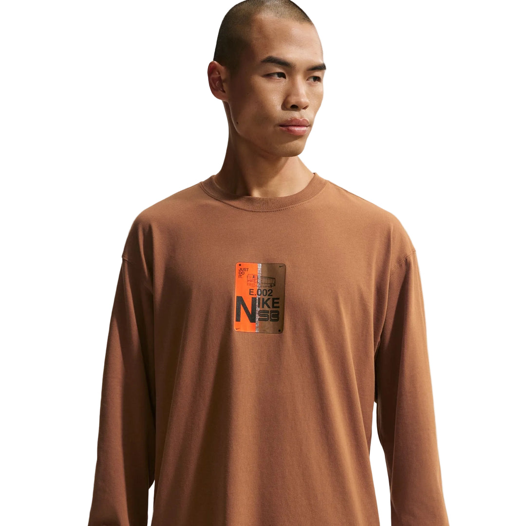 Man wearing a brown long-sleeve shirt with a Nike logo 