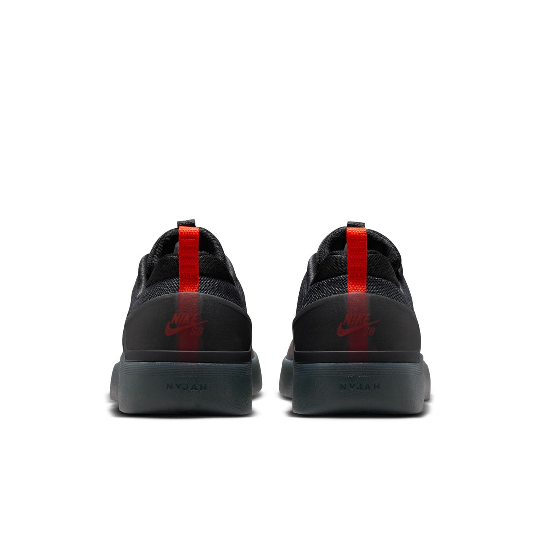 Black sneakers with red accents on a white background