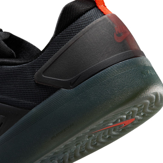 Close-up of a black and gray sneaker with red accents on a white background