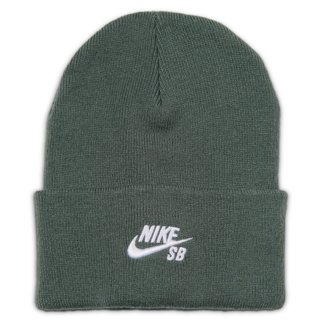 A dark green ribbed knit beanie hat with a white embroidered Nike SB logo on the front cuff, shown against a plain white background.