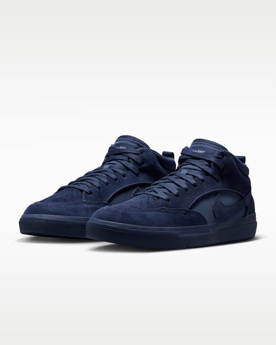 A pair of Nike high-top sneakers in dark navy blue suede, shown from a three-quarters angle on a light gray studio background.