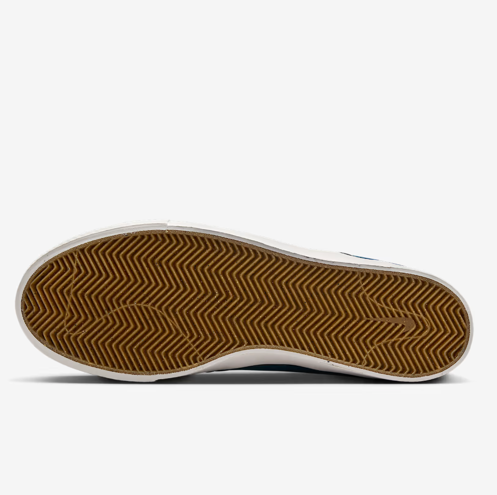 Close-up of a shoe sole with brown tread pattern on a white background