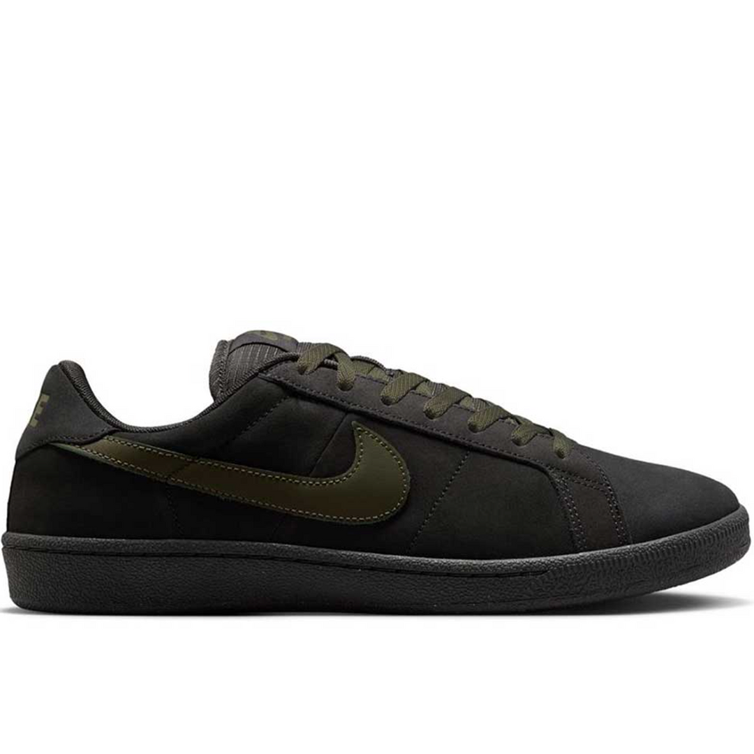 A low-top Nike sneaker in black suede and mesh with an olive green Swoosh and matching laces, shown in a side profile on a white background.