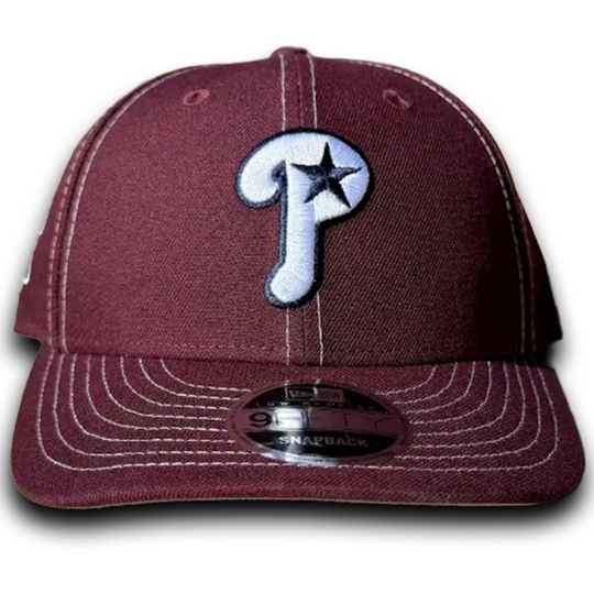 Maroon baseball cap with a logo on a white background
