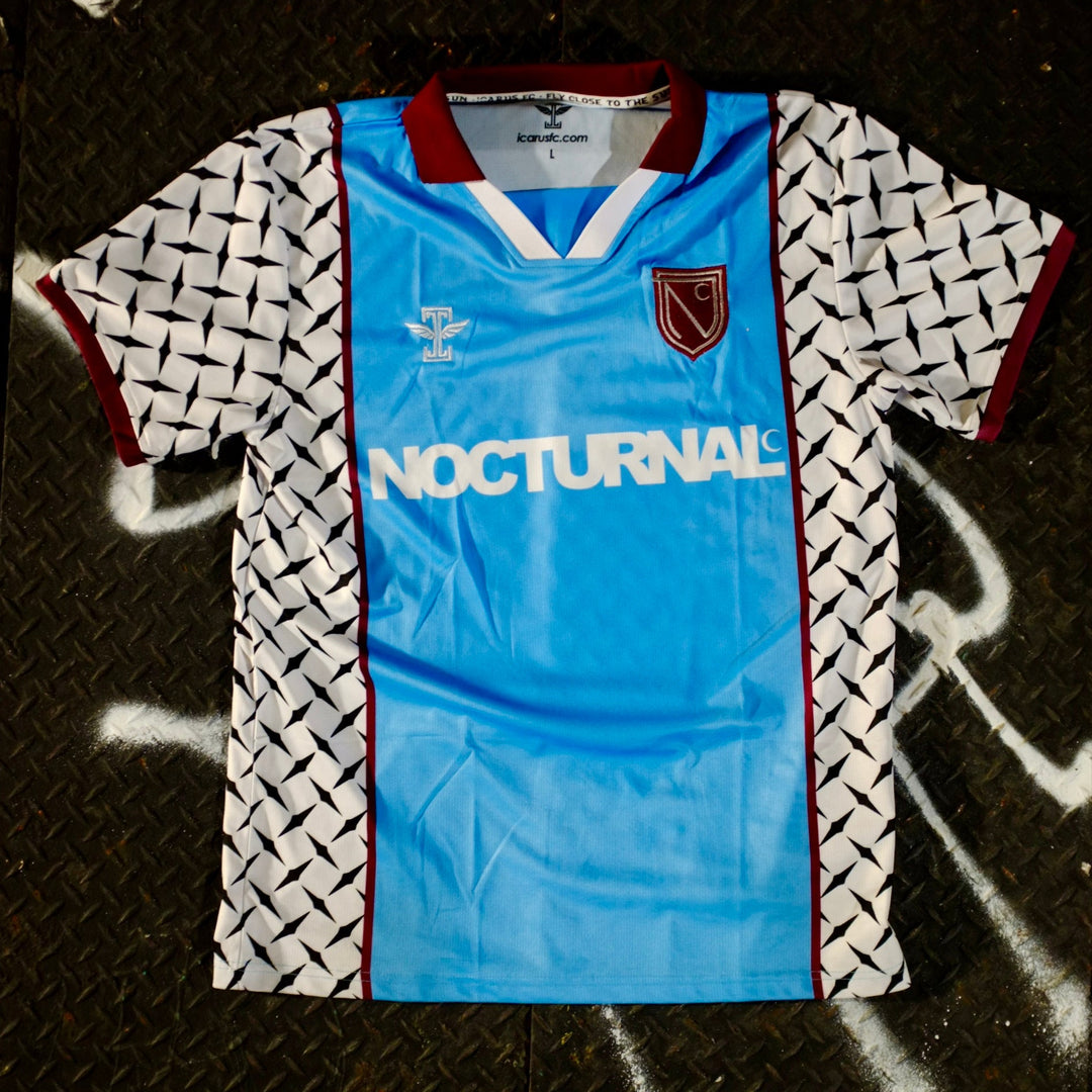 Blue sports jersey with 'Nocturnal' text on a textured surface