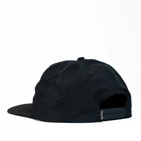 Black cap with 'The North Film Club logo on a white background