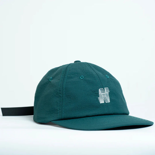 teal green cap with a N logo on a white background