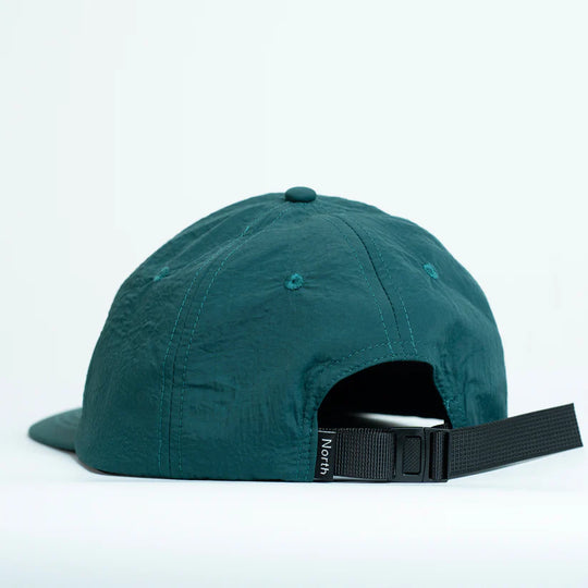Teal cap with a black nylon strap 