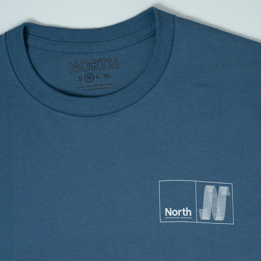Blue t-shirt with 'North' logo and text on a light gray background