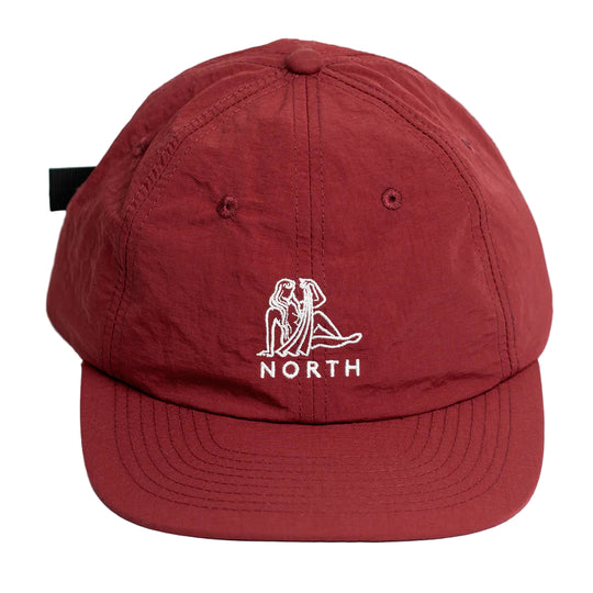 Red cap with a white North logo and text on a white background