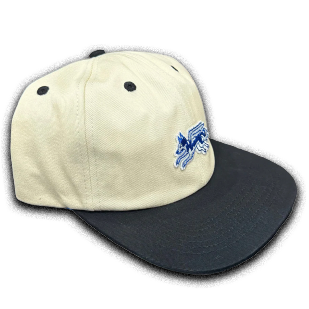 Two-tone cap with beige front and black back, featuring a logo on the beige side.