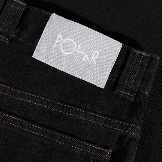 Close-up of a black jean with a 'Polar' label.