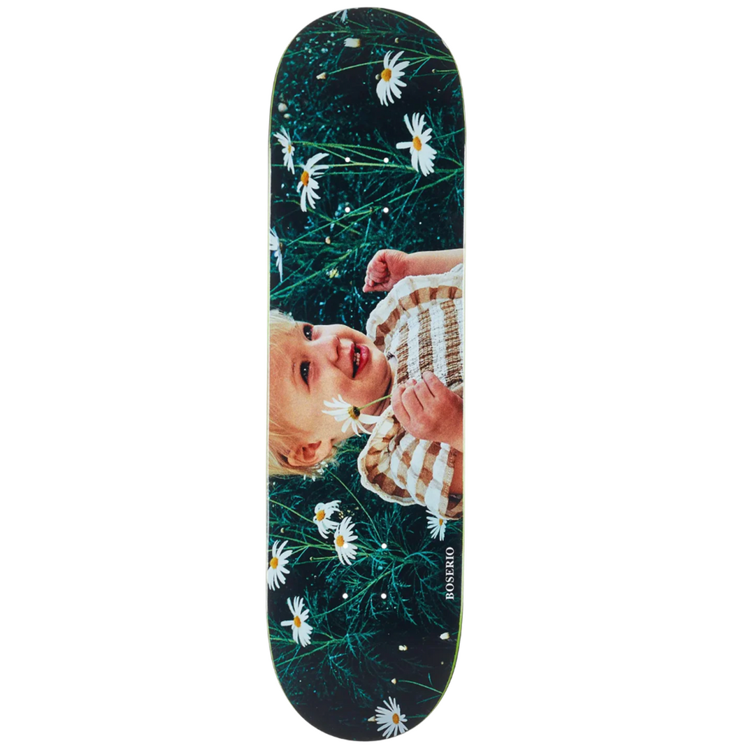 Skateboard deck with a baby and floral design on a dark background