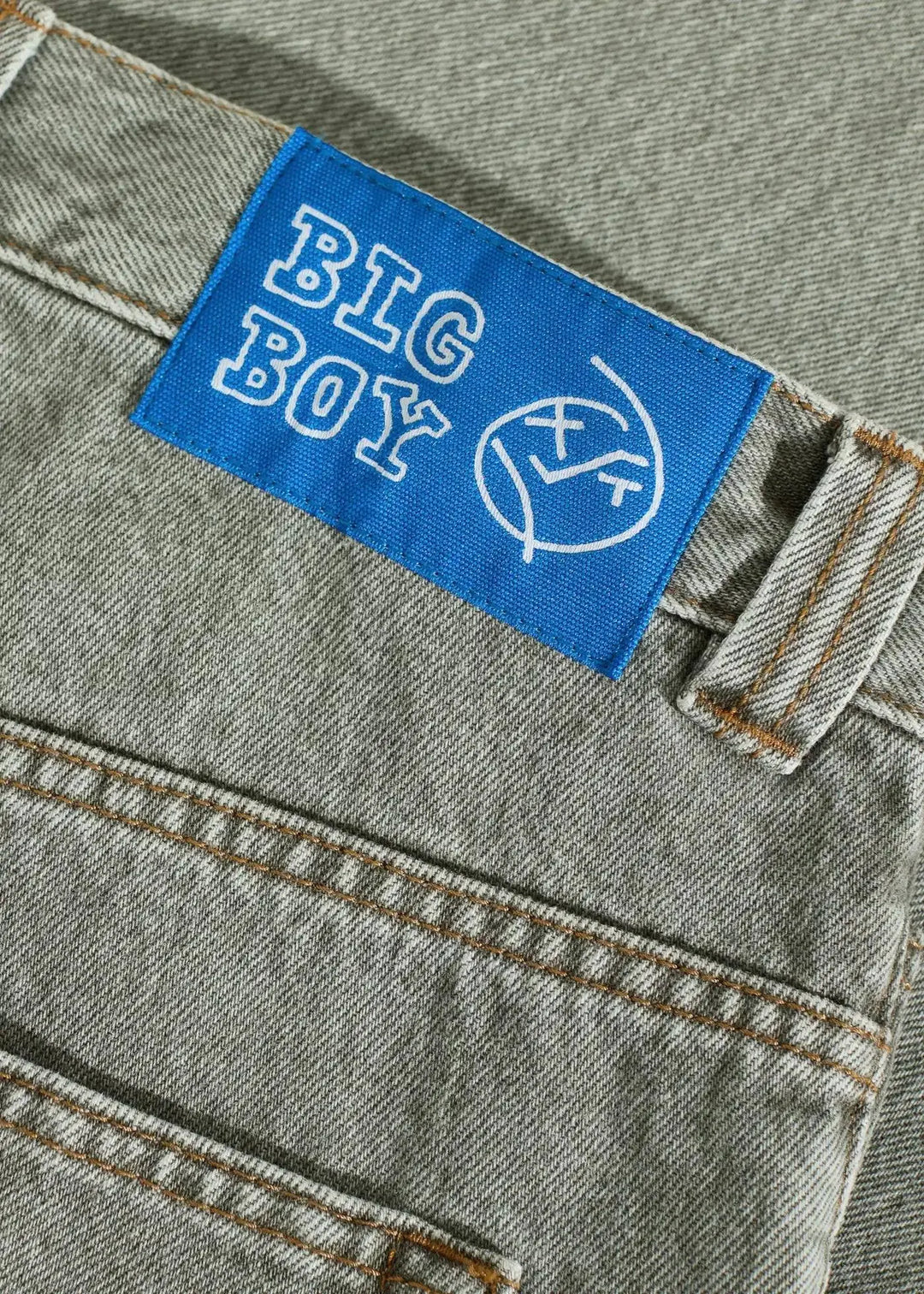 Blue label with 'BIG BOY' logo on a denim jean