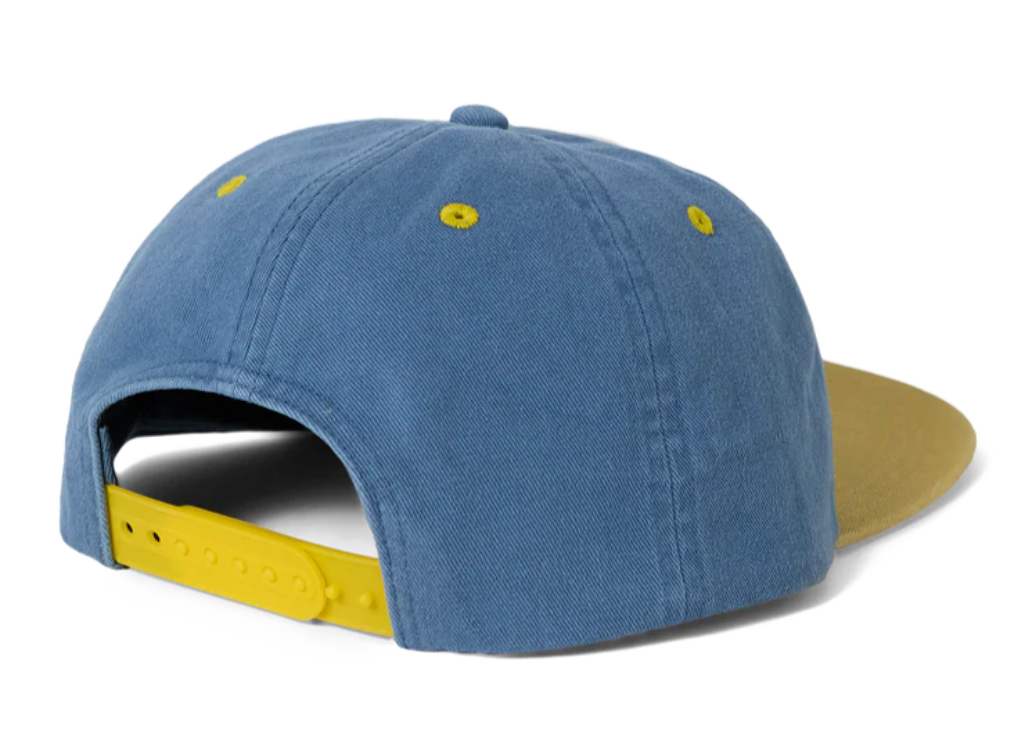 Blue cap with yellow interior and strap on a white background