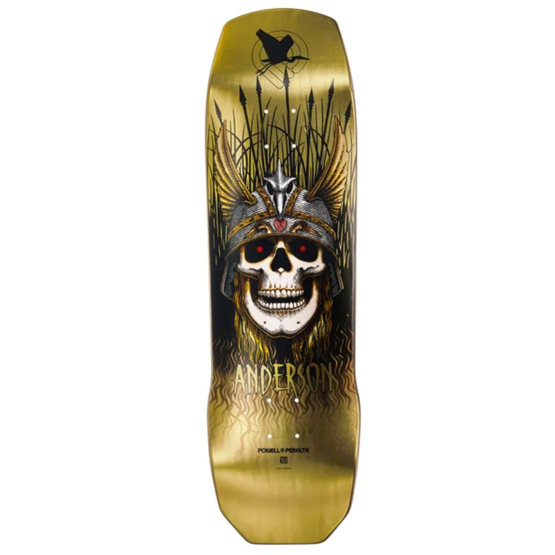 Skateboard deck with skull and feather design on a gold background