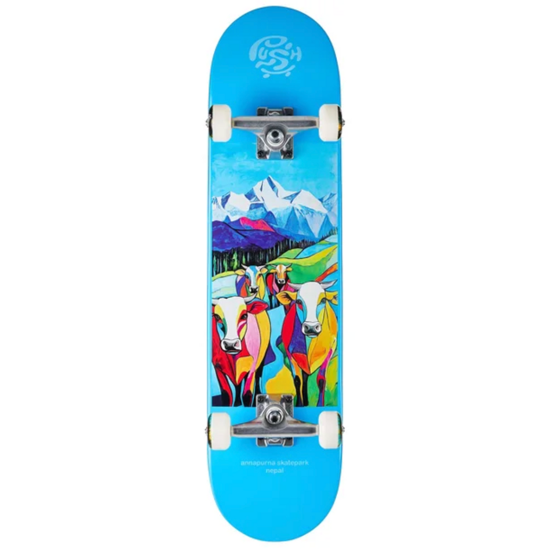 Skateboard with colorful cow design and mountain background on a blue deck