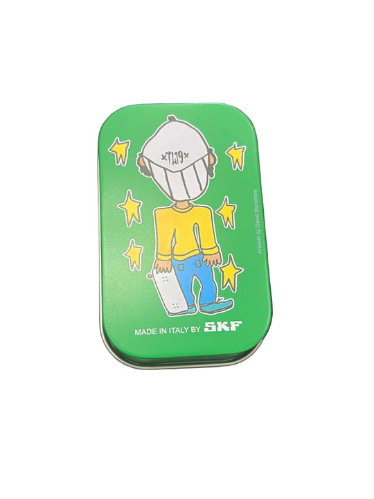 Small green tin with cartoon design on a black background