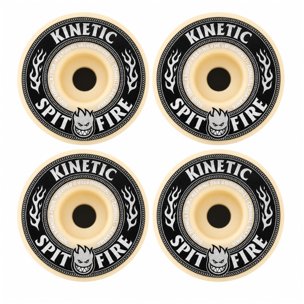 Four skateboard wheels arranged in a 2x2 grid on a plain white background. Each wheel has a black outer ring with cream-colored text reading &
