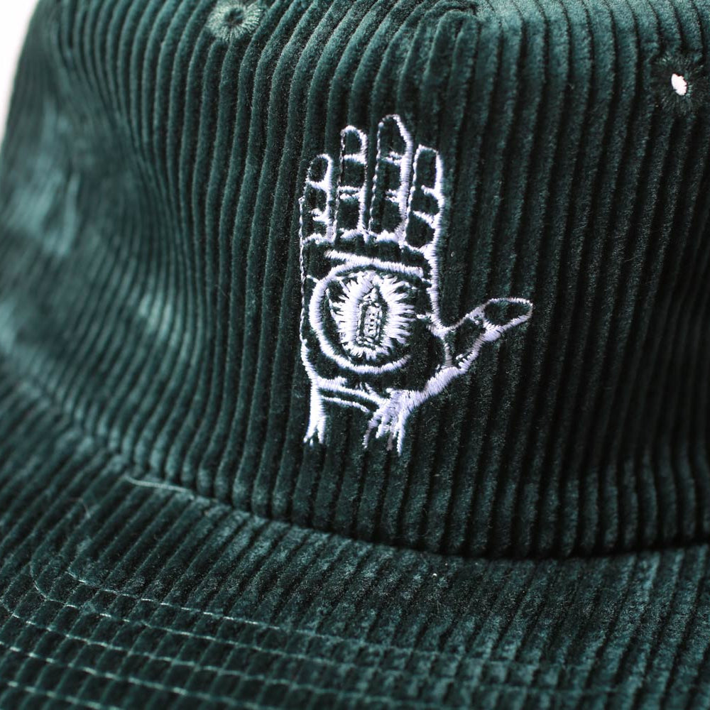 Dark green corduroy bucket hat with a white embroidered design on a light gray background