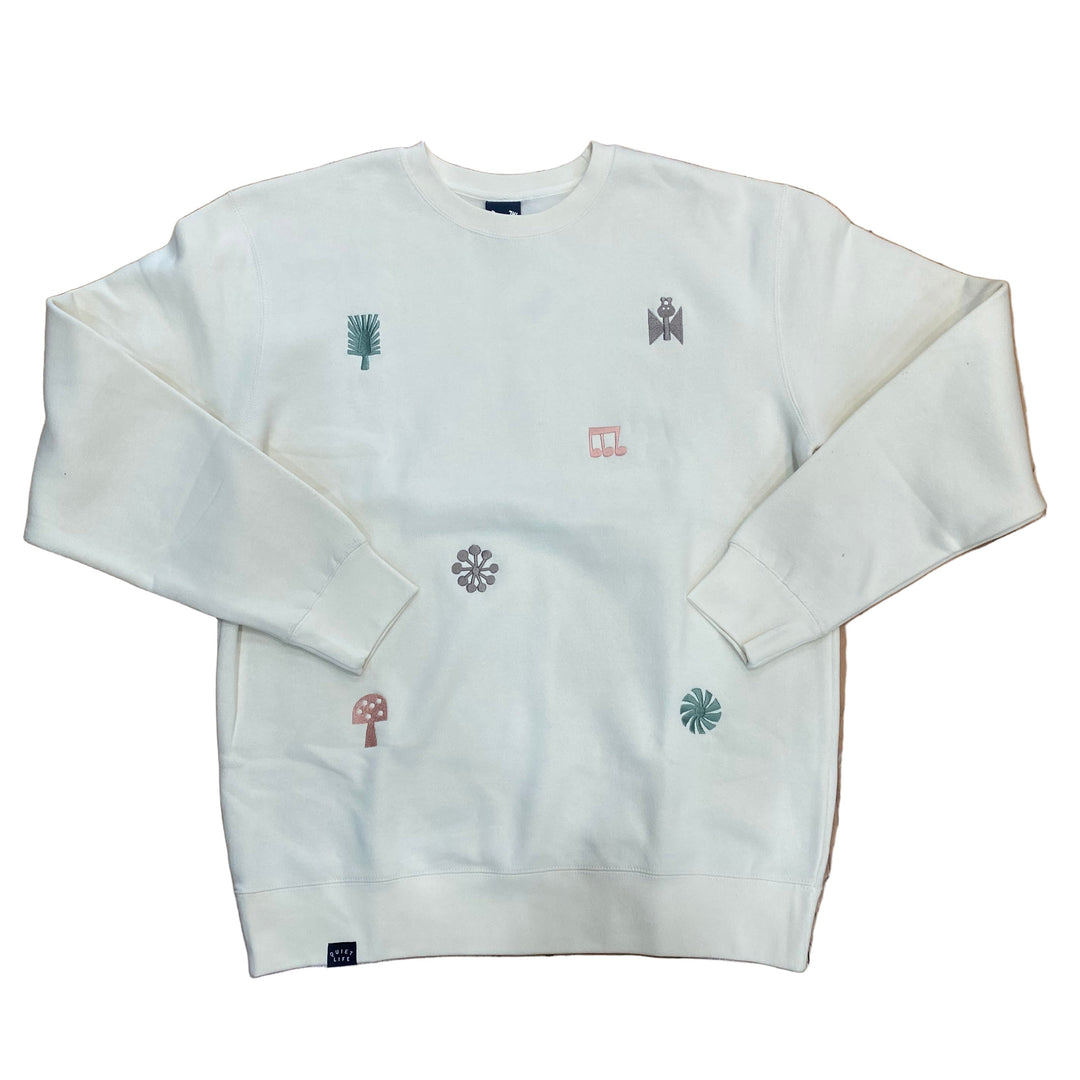 White sweatshirt with embroidered designs on a white background