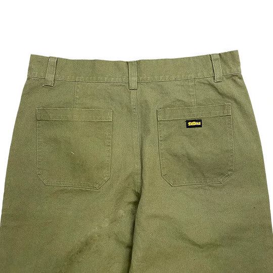 Green pants with a theories brand label on back