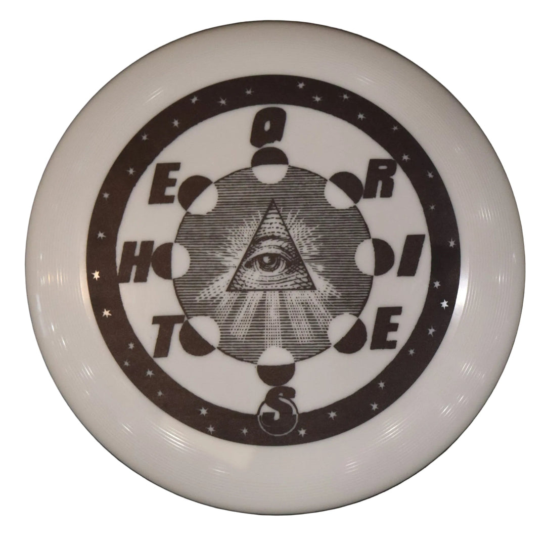 White disc with black circular design featuring an eye symbol on a dark background