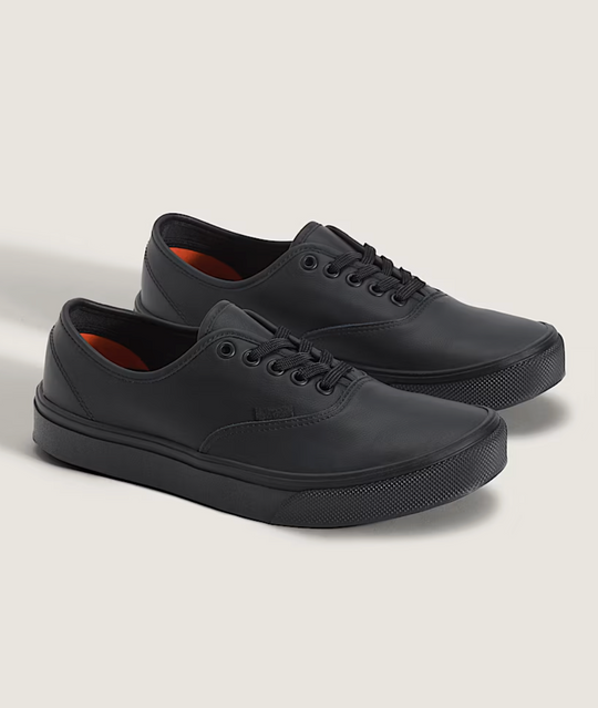 Pair of black sneakers on a light gray background