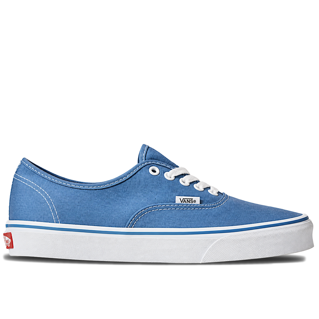 A single Vans classic low-top sneaker in a medium blue canvas finish, featuring white laces, a white rubber sole, and a thin blue stripe along the midsole, set against a plain white background.