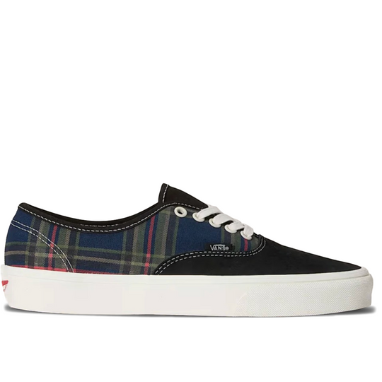 A Vans classic low-top sneaker featuring a navy blue and red plaid pattern on the side panels, a black canvas toe, white laces, and a thick white rubber sole.