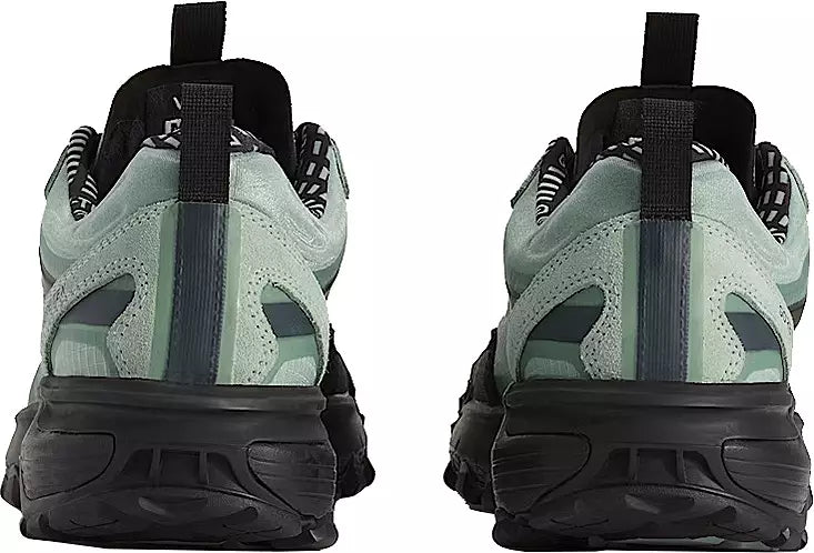 Pair of green and black sneakers shown from the back on a white background
