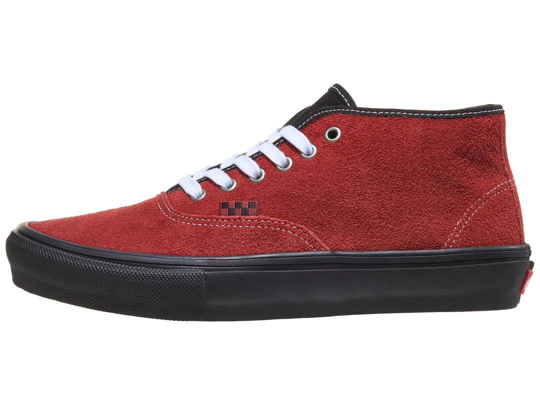 Red high-top sneaker with black sole on a white background
