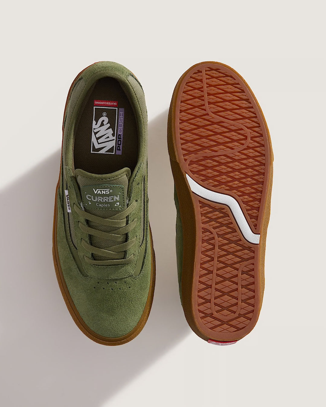 Green sneaker with brown sole on a white background