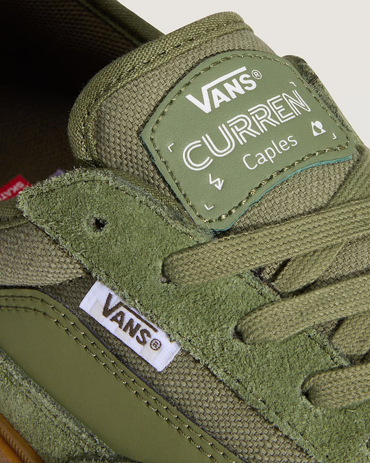 Green Vans shoe with a 'Curren Caples' patch on a white background