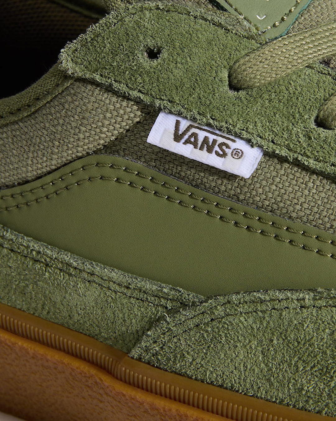 Close-up of a green Vans sneaker with brand logo.