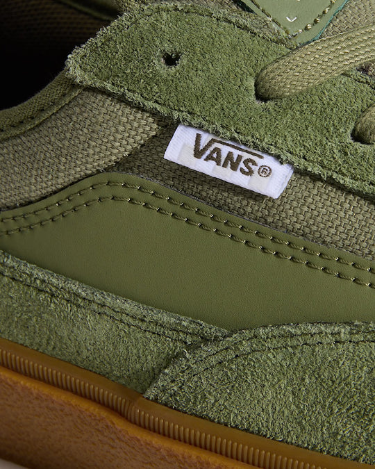 Close-up of a green Vans sneaker with brand logo.