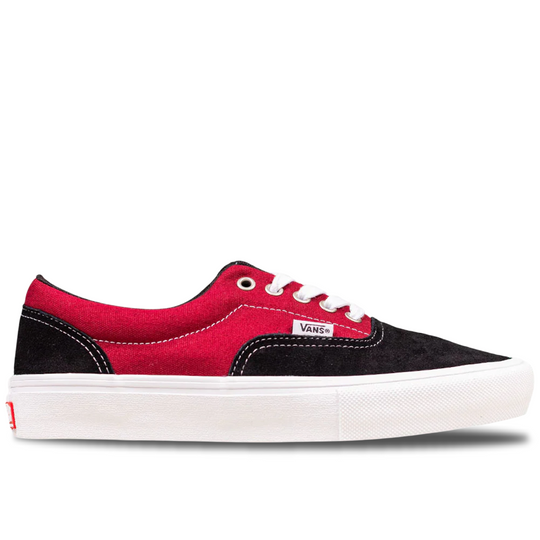 Red and black Vans sneaker on a white background