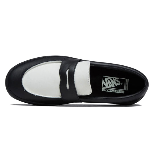 Black and white slip-on shoe with Vans branding on a white background