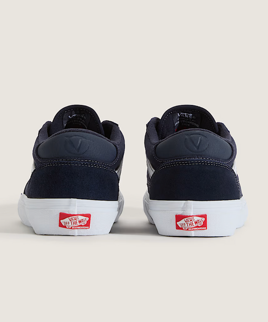 Navy sneakers with a red label on a beige background