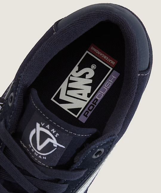 Navy blue Vans sneaker with pop cush 
brand logo on a light gray background