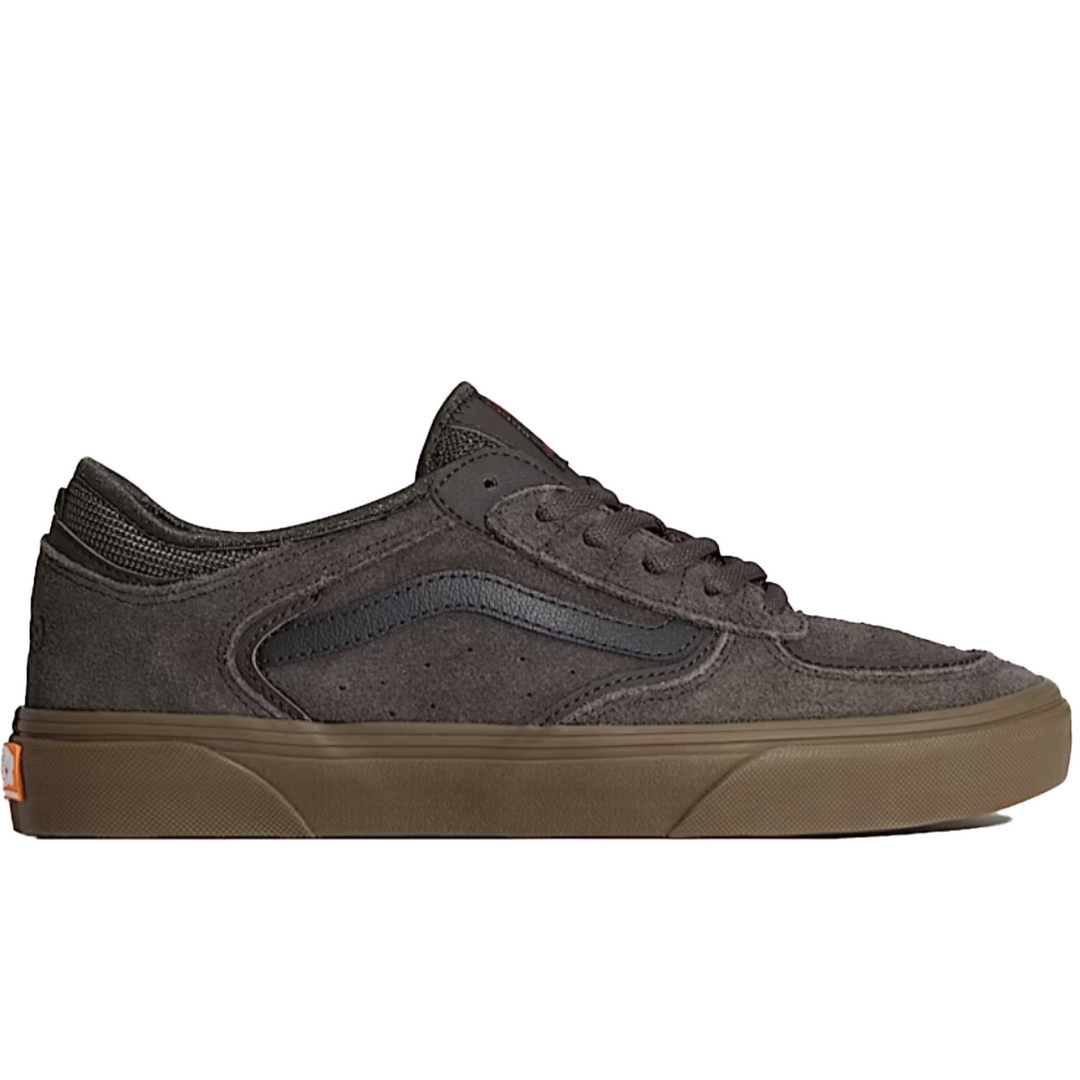 Dark sneaker with brown sole on a white background