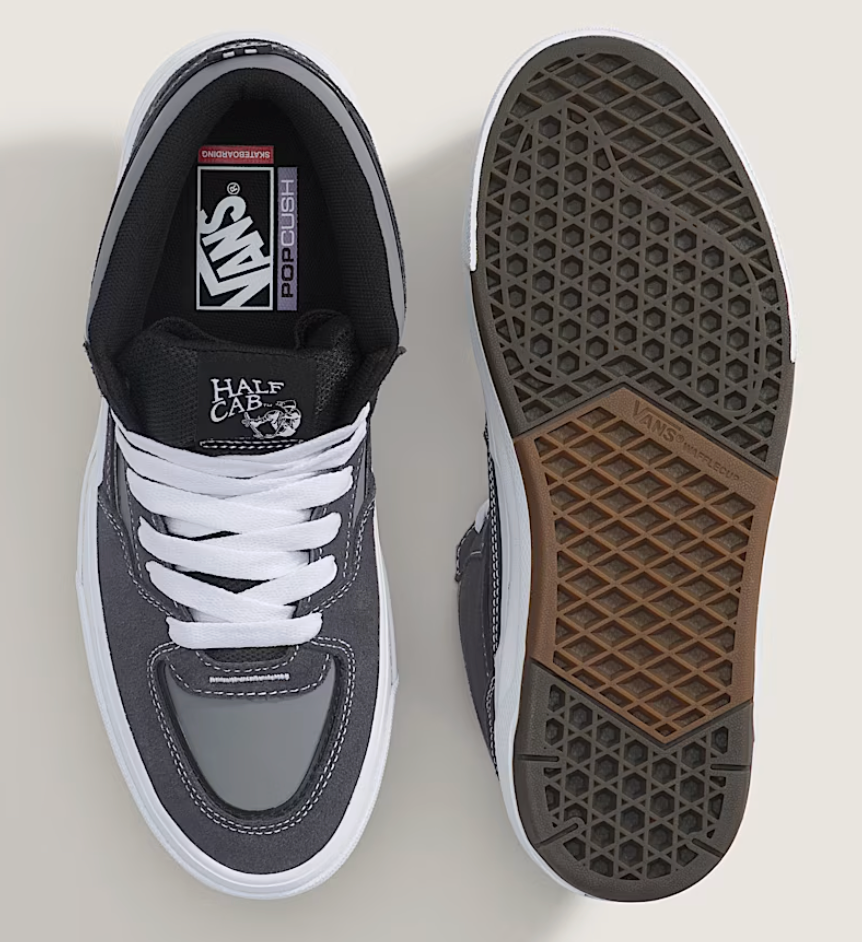 Gray sneakers with white laces on a light gray background