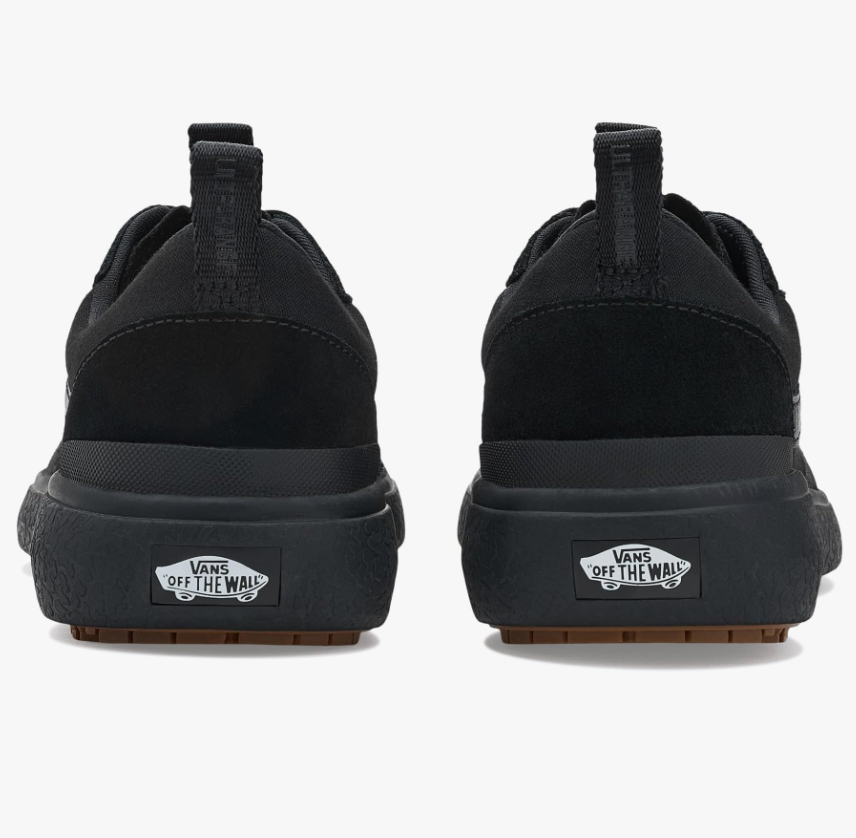 Black Vans sneakers shown from the back on a white background