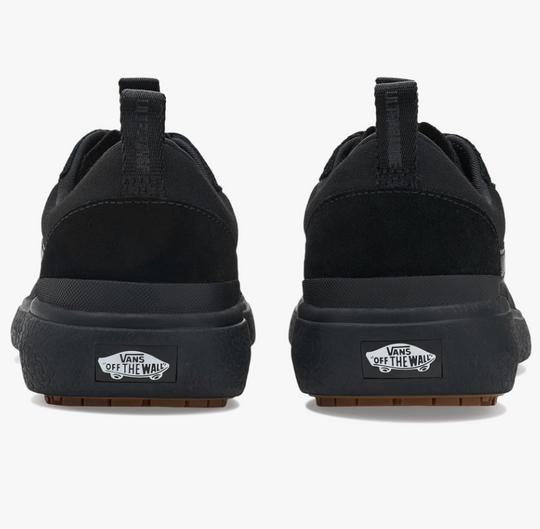 Black Vans sneakers shown from the back on a white background