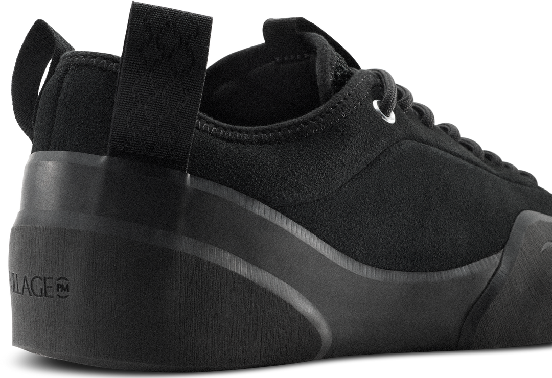 Black sneaker with a thick sole on a white background