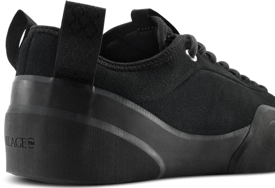 Black sneaker with a thick sole on a white background