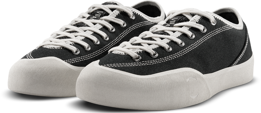 Black sneakers with white laces on a white background